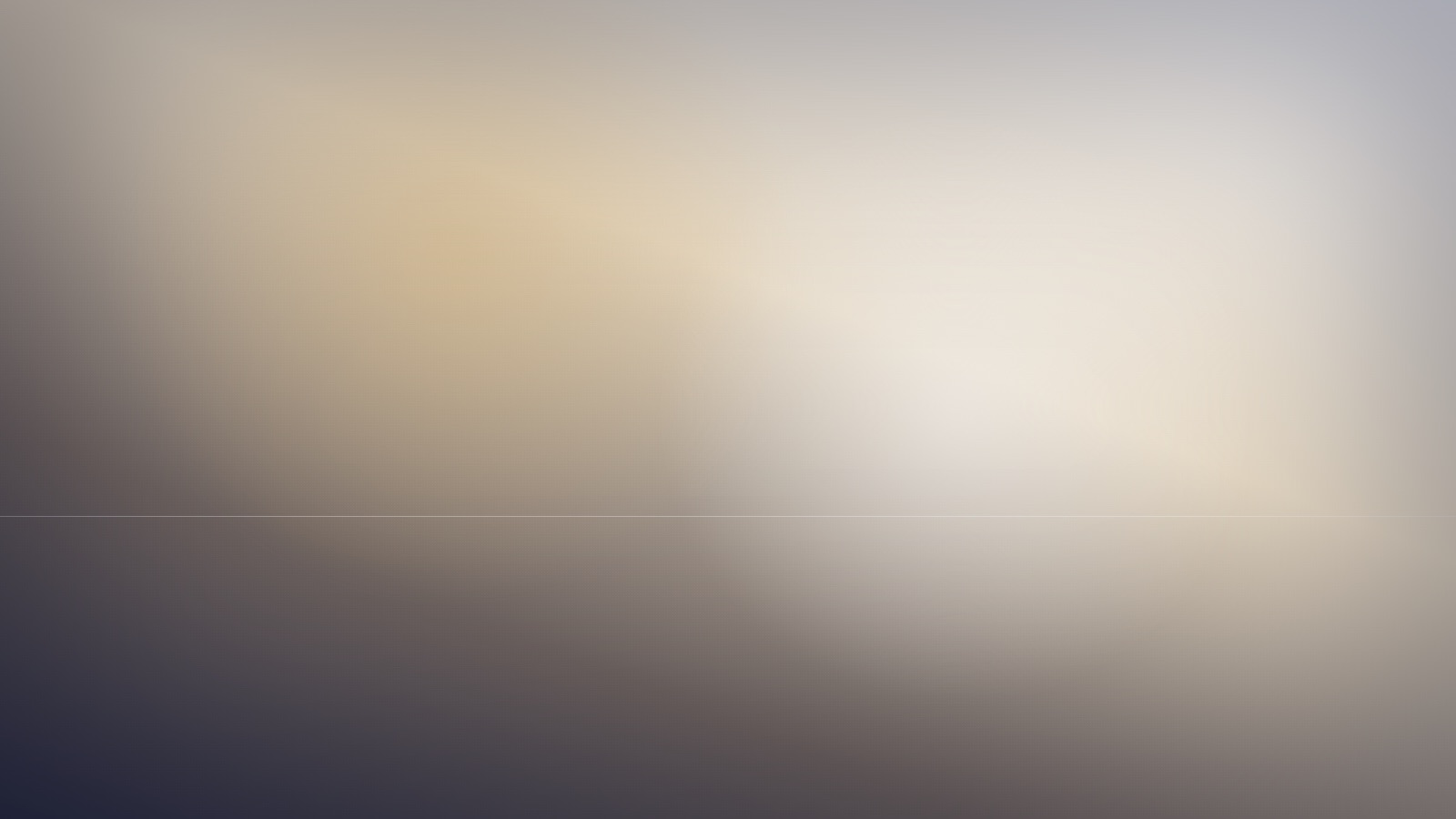 A calm open field of gentle colour under a steady, quiet light.